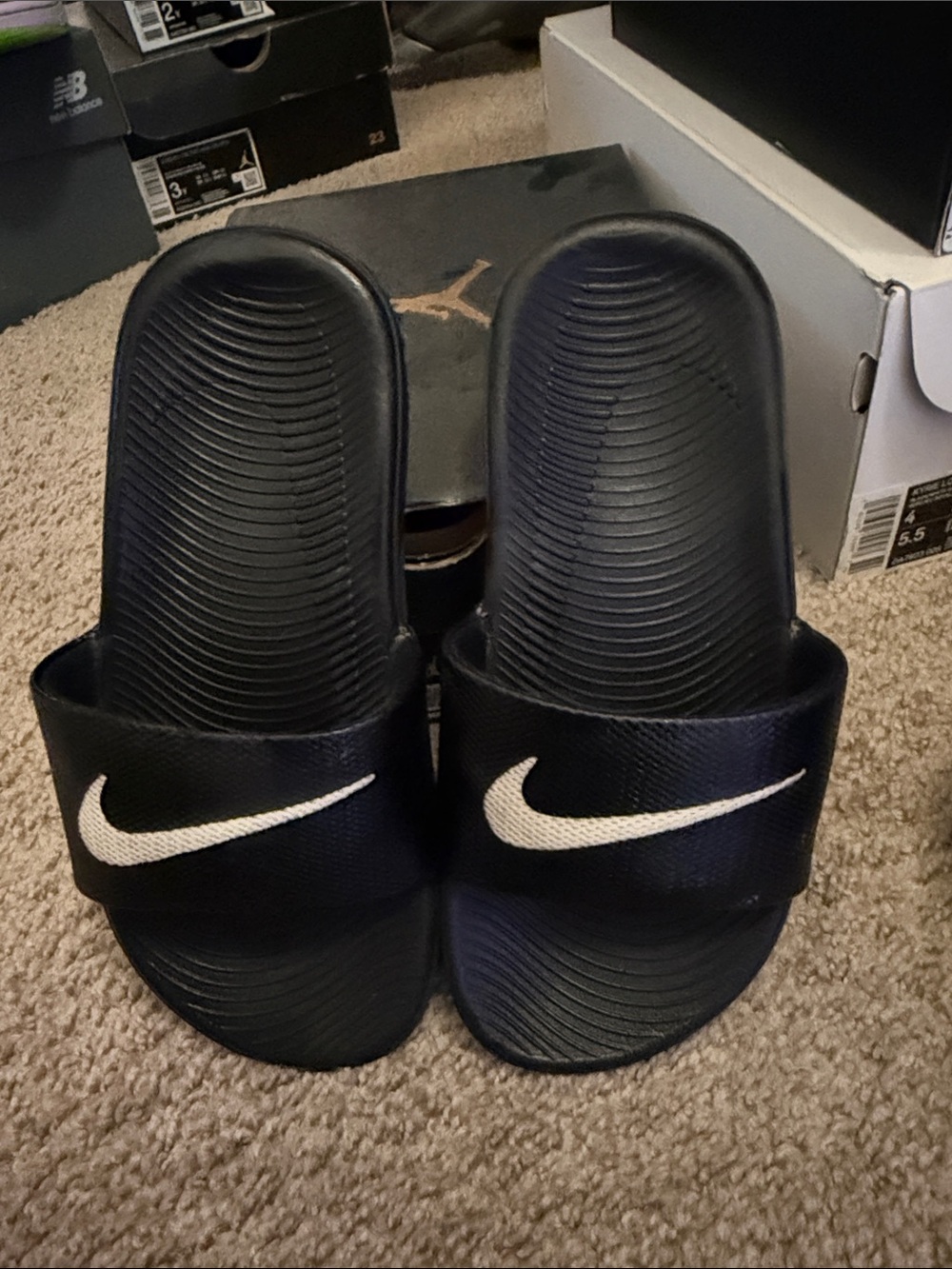 Nike Black Slides with White Swoosh Logo